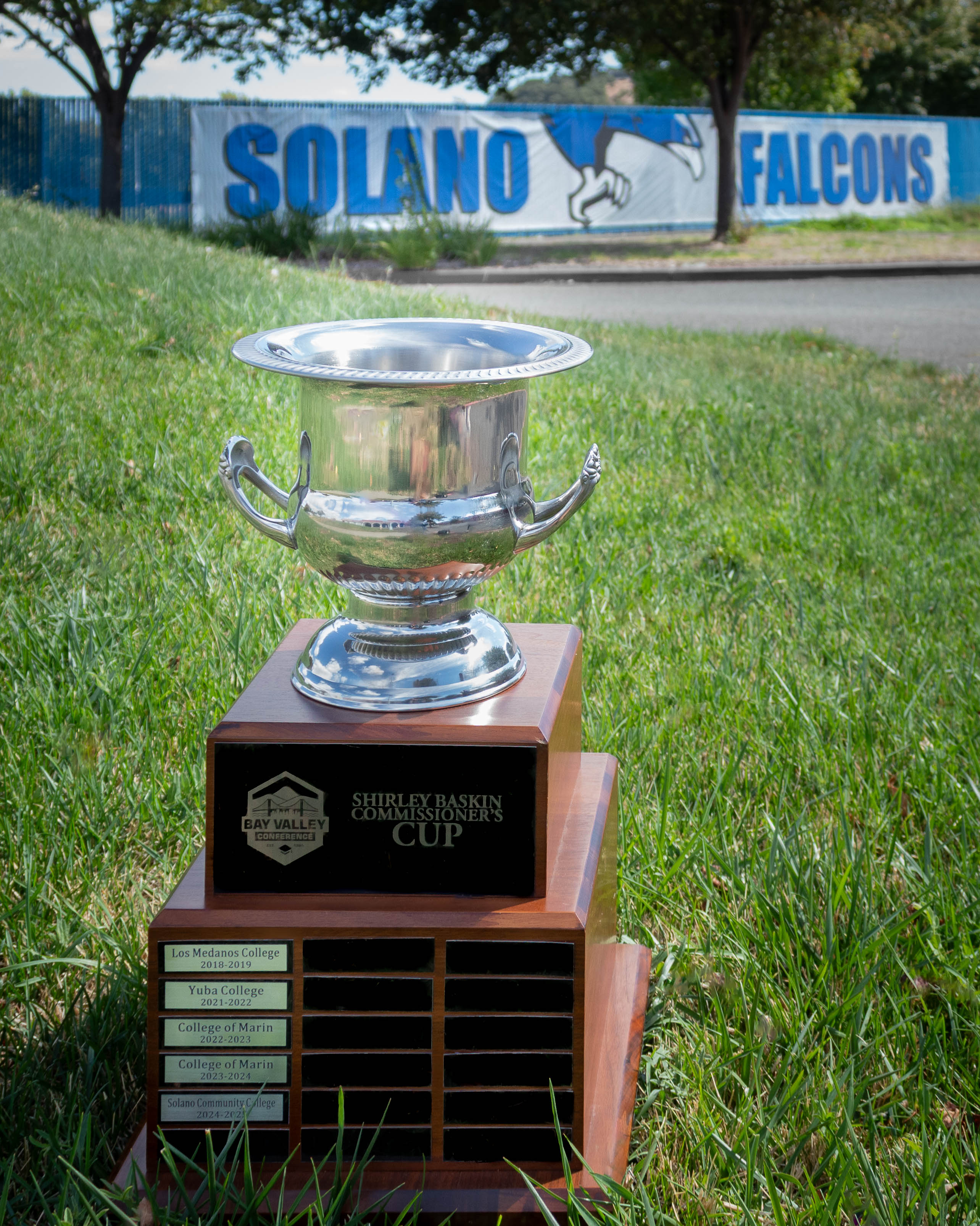Bay Valley Commissioner's Cup sits in grass with Solano Falcon banner in background